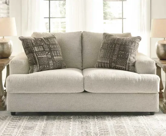 Cozy beige sofa with patterned cushions in living room.