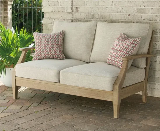 Outdoor wooden loveseat with cushions and pillows.