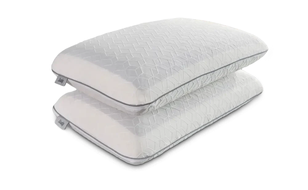Two stacked white pillows with geometric pattern