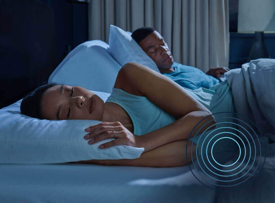 Couple sleeping peacefully in bed at night.