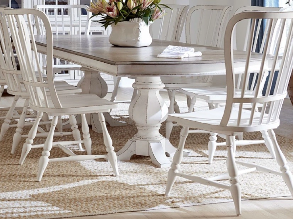 Rustic dining table with white chairs and rug