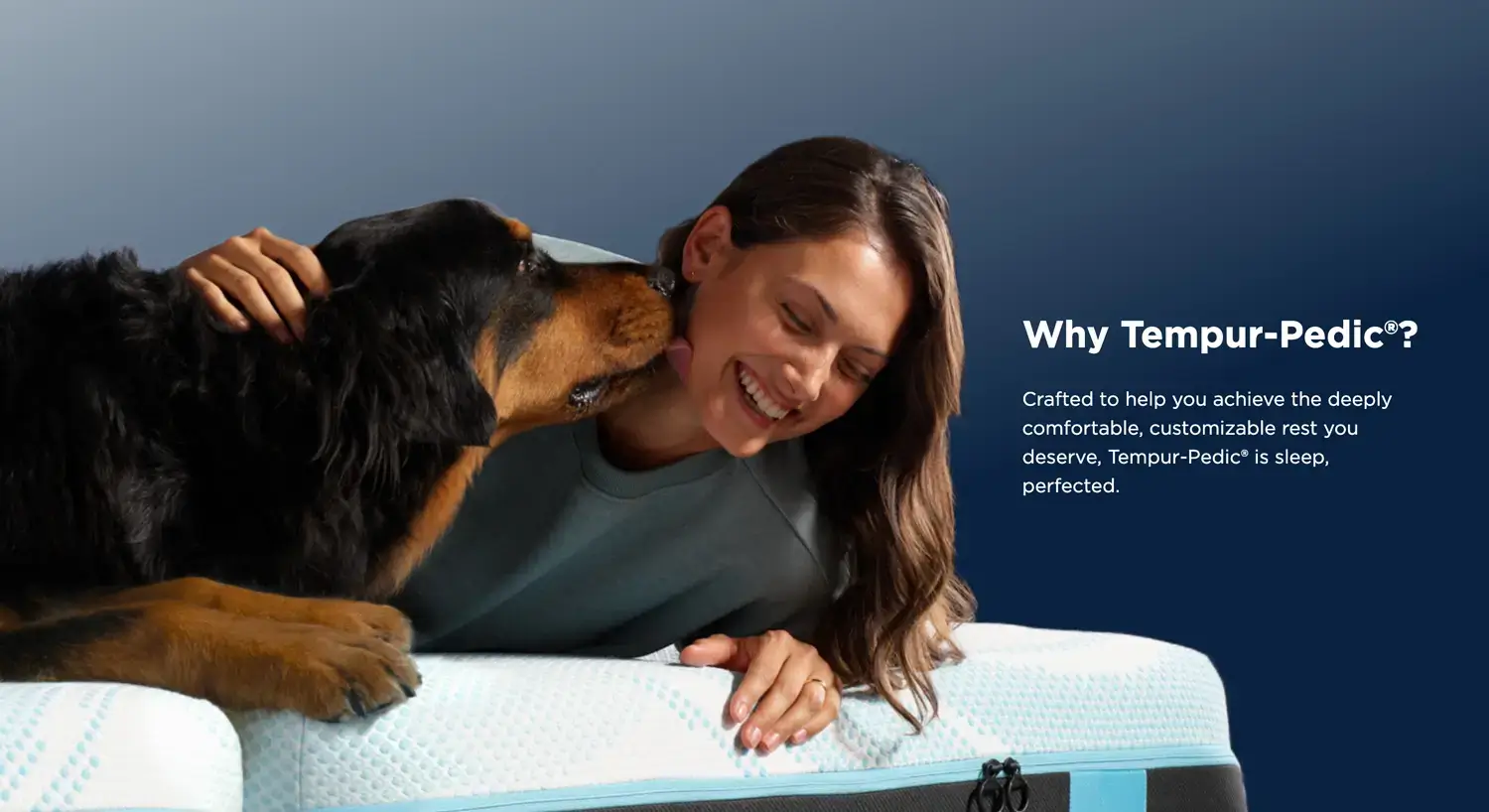 Woman and dog on Tempur-Pedic mattress, smiling happily.